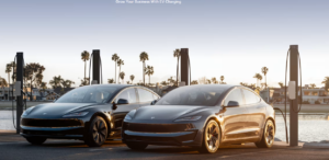 Two Tesla vehicles charging with wall connectors at a waterfront commercial site